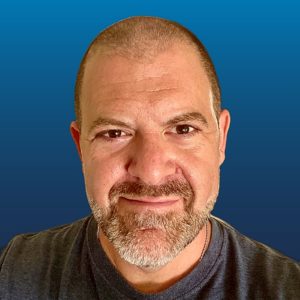 Image of Loren Weisman head and face in front of a blue background